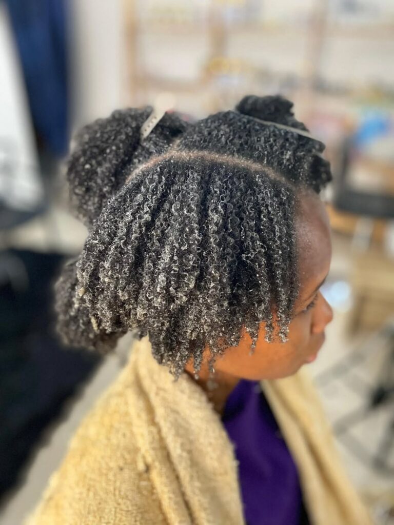 a lady applying deep conditioner on her hair