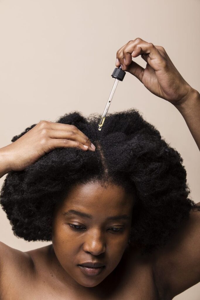a lady moisturizing her Afro Hair