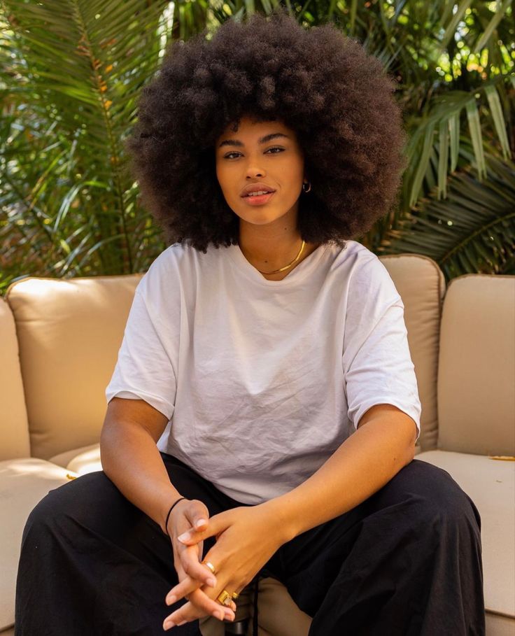 a fair girl with afro hair sitting down