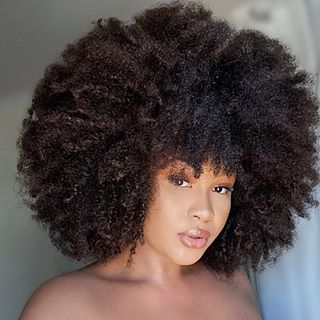a girl with full afro low porosity hair