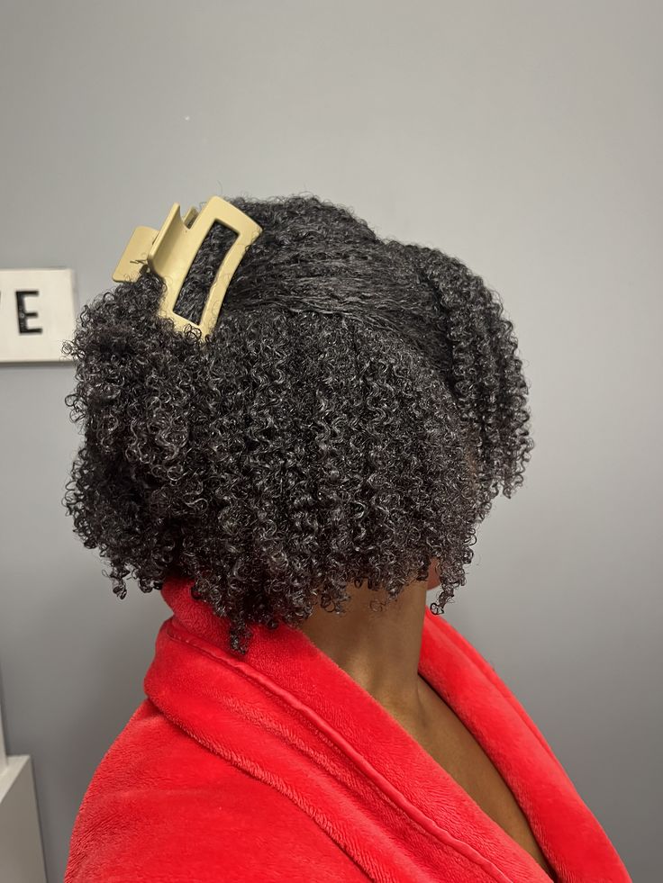 someone with afro hair with clip