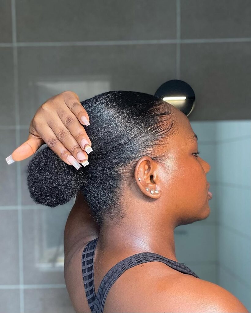 a lady with afro low puff beautiful afro hairstyle