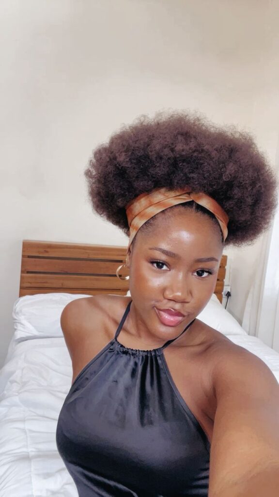 a girl with afro puff with headband style