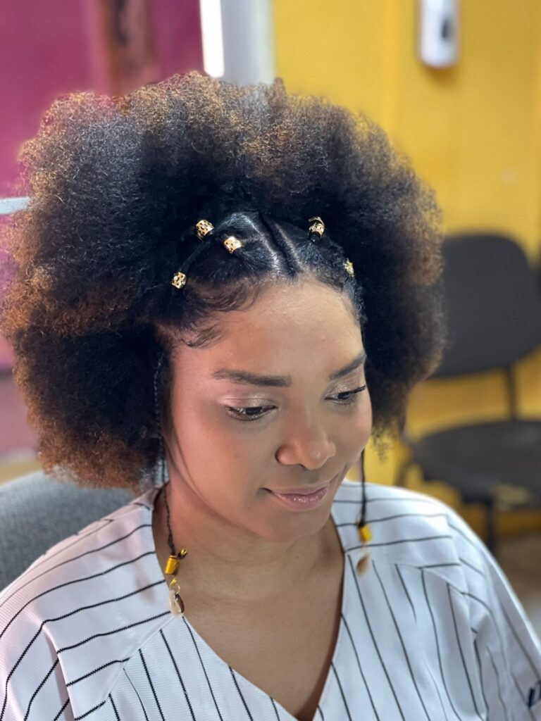 a lady with afro puff with jewelry