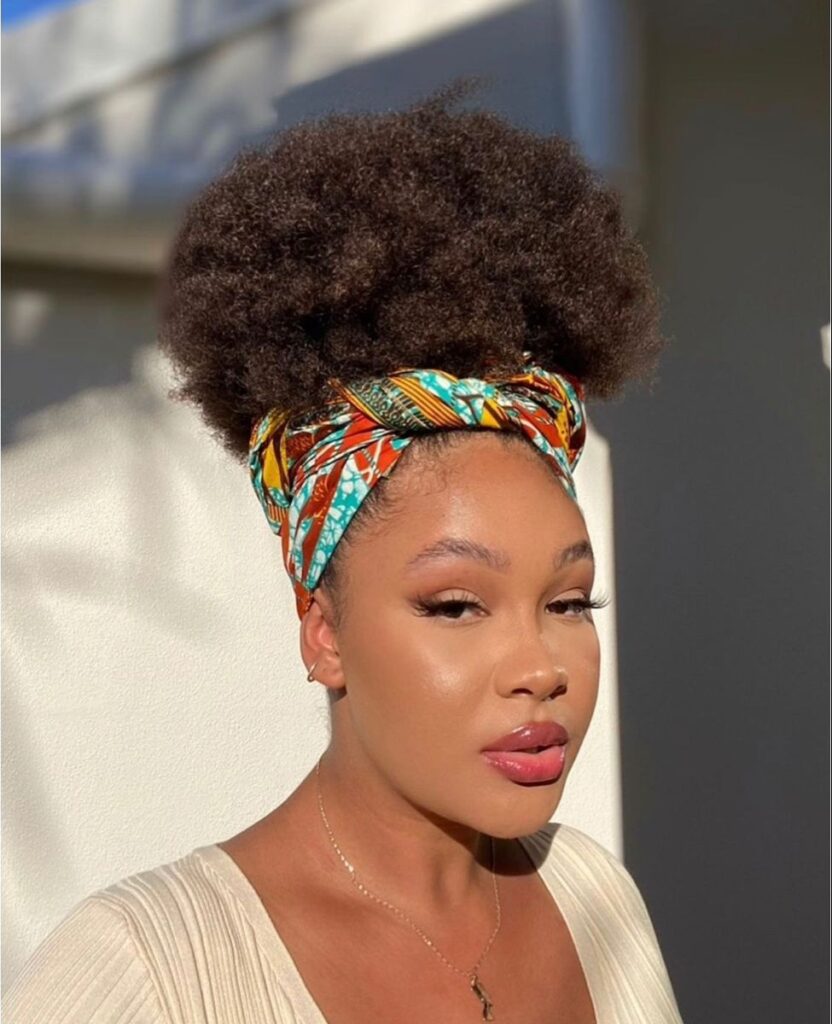 a lady with afro puff with scarf style