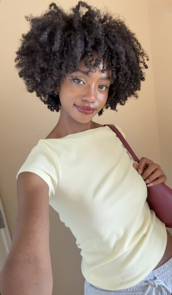 a lady with afro with defined parts