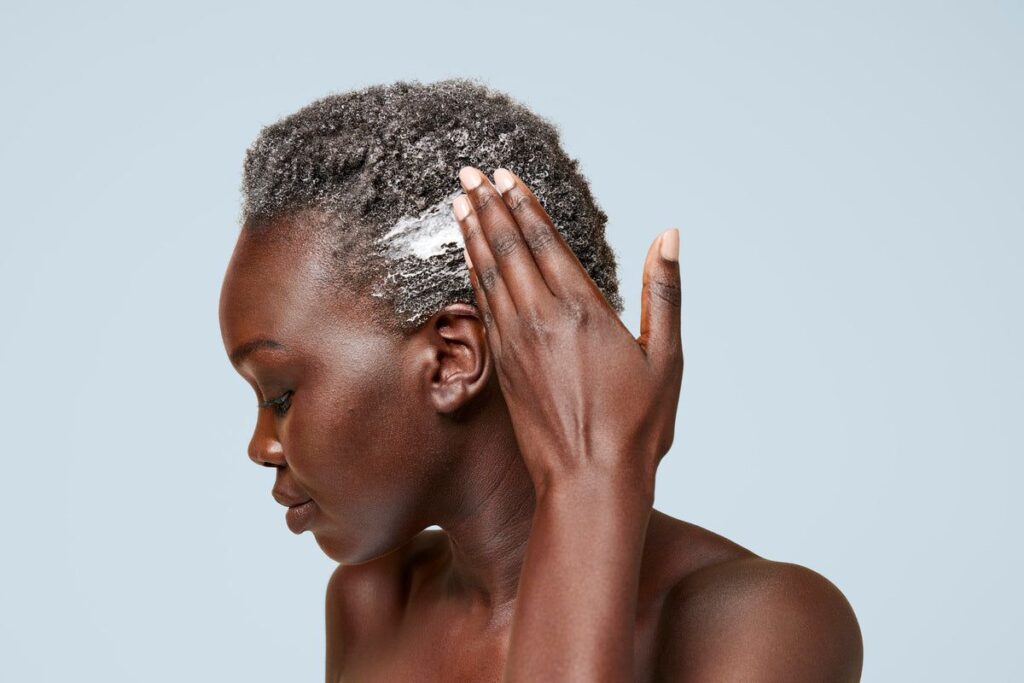 someone applying conditioner to her type 4 hair