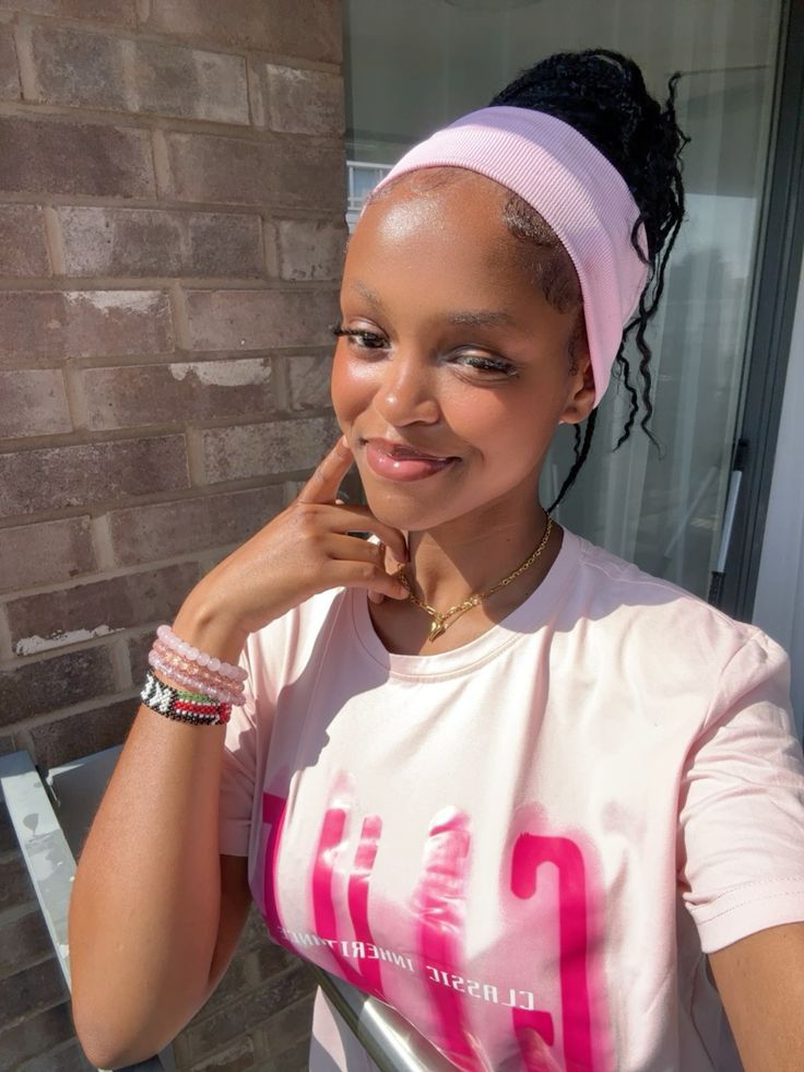 a girl with braids with pink headband