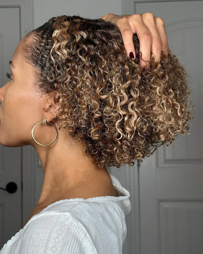 a girl with brown curly afro