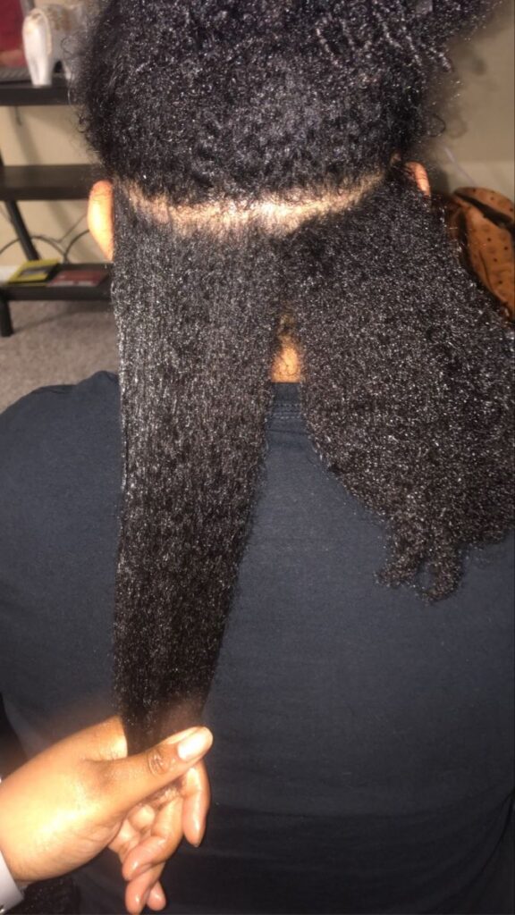 someone checking her hair porosity