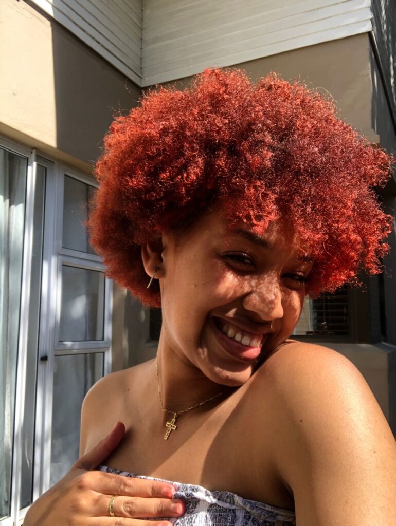 a lady with colored afro