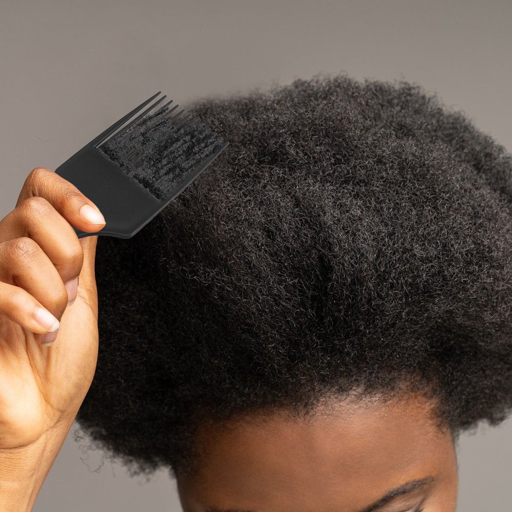 someone combing her hair
