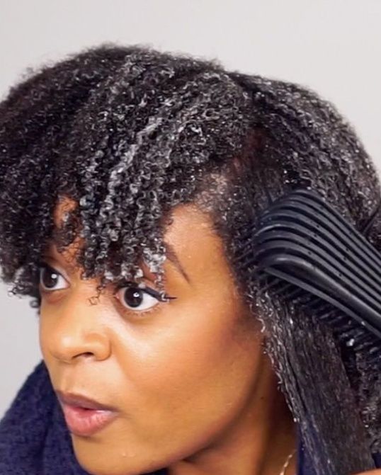 someone detangling hair from the end