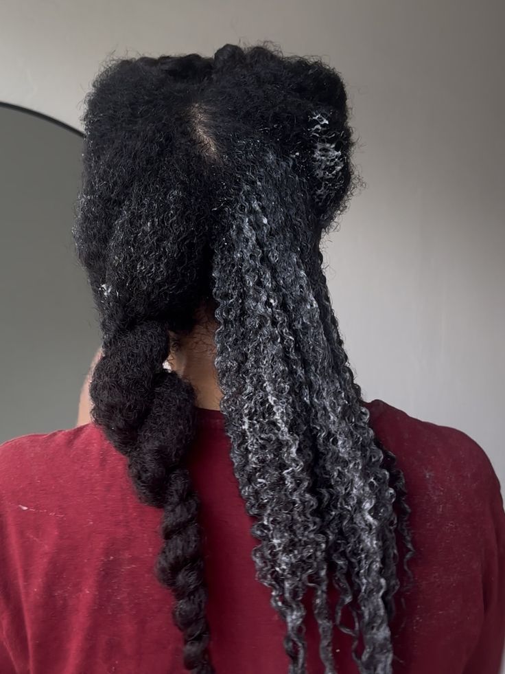 a lady detangling her hair as part of her wash day routine