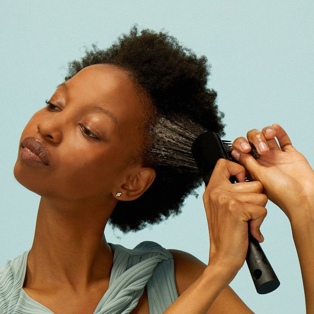 someone detangling her hair
