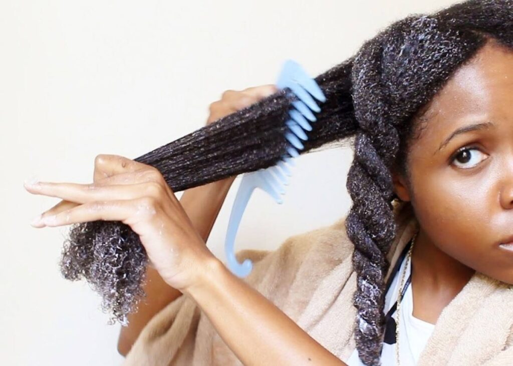 someone detangling her hair by sections