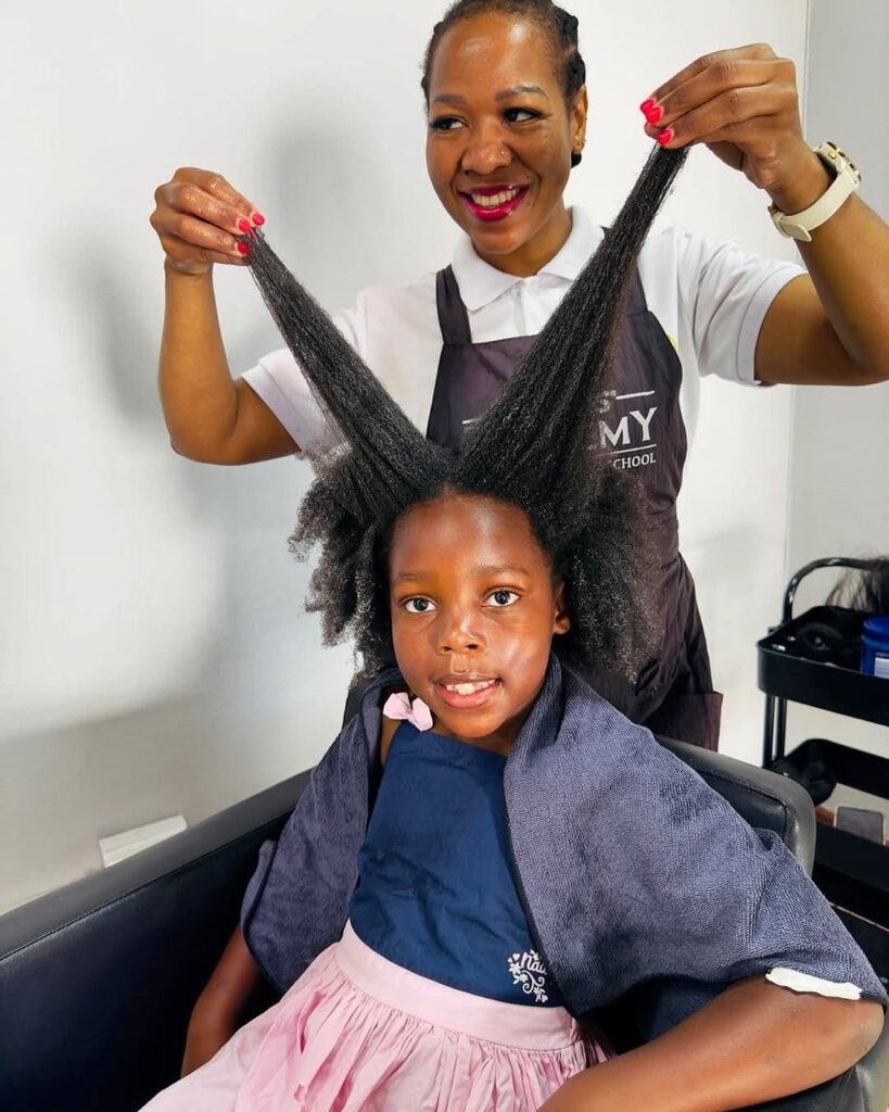 someone detangling kid's hair with hand