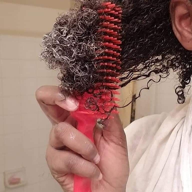 someone detangling her hair