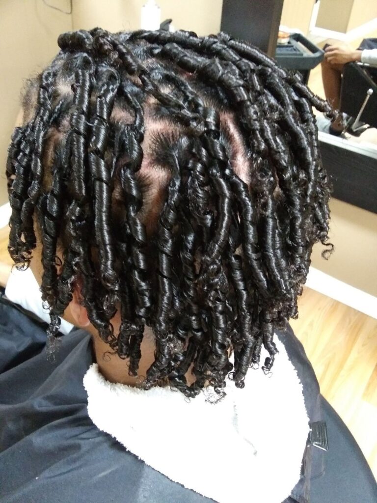 Finger coil technique on natural Afro hair with defined coils.