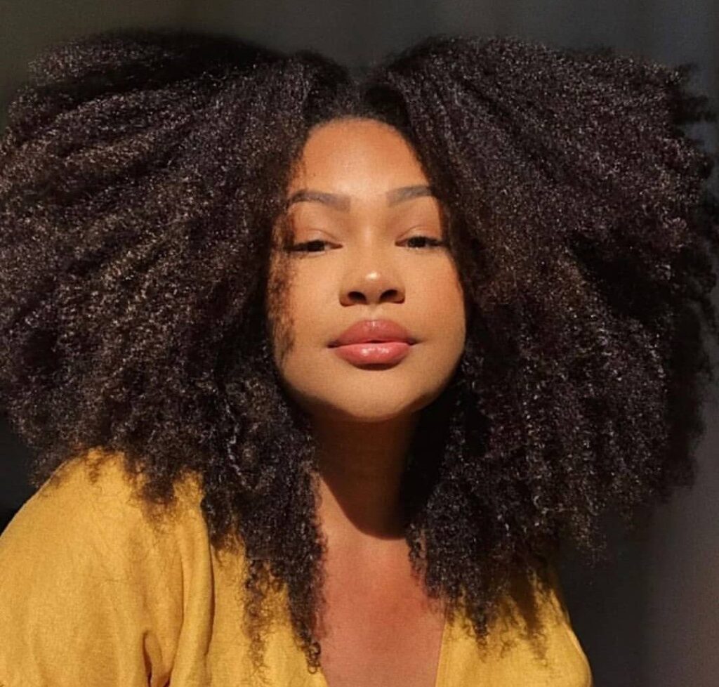girl with full type 4C hair comparing her hair type with 4A vs 4B hair
