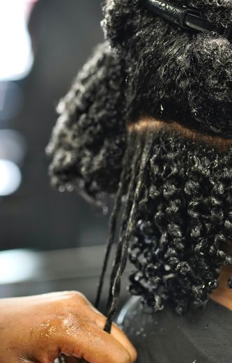someone moisturizing her hair