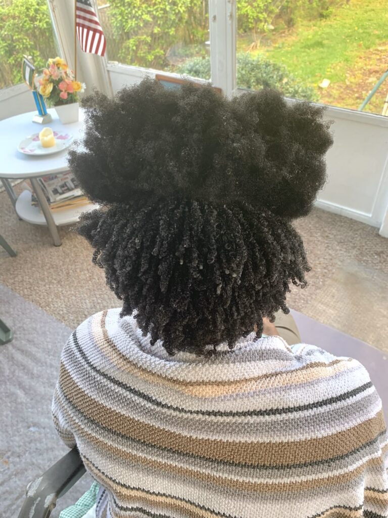 a lady moisturizing her hair