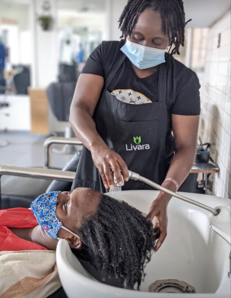 someone washing her hair in a hair salon