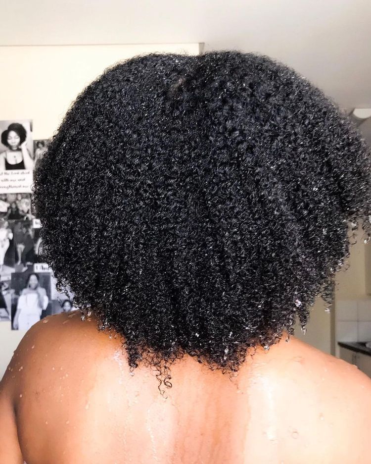 someone that washed her hair as part of hair growth routine for afro hair