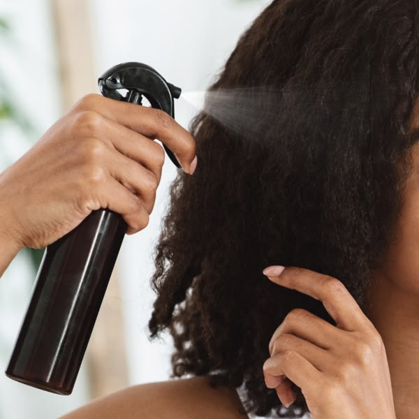 someone applying hair care product