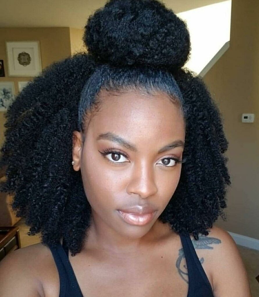 a lady with half up half down beginners afro hairstyle