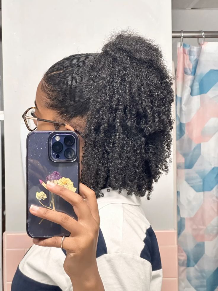 Half-up natural curly hairstyle on Afro hair.