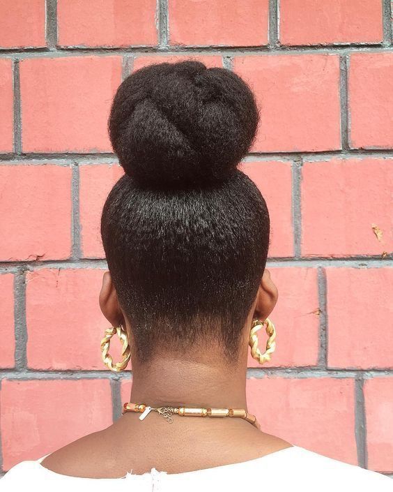 a lady with afro low bun as a simple beginners afro hairstyle