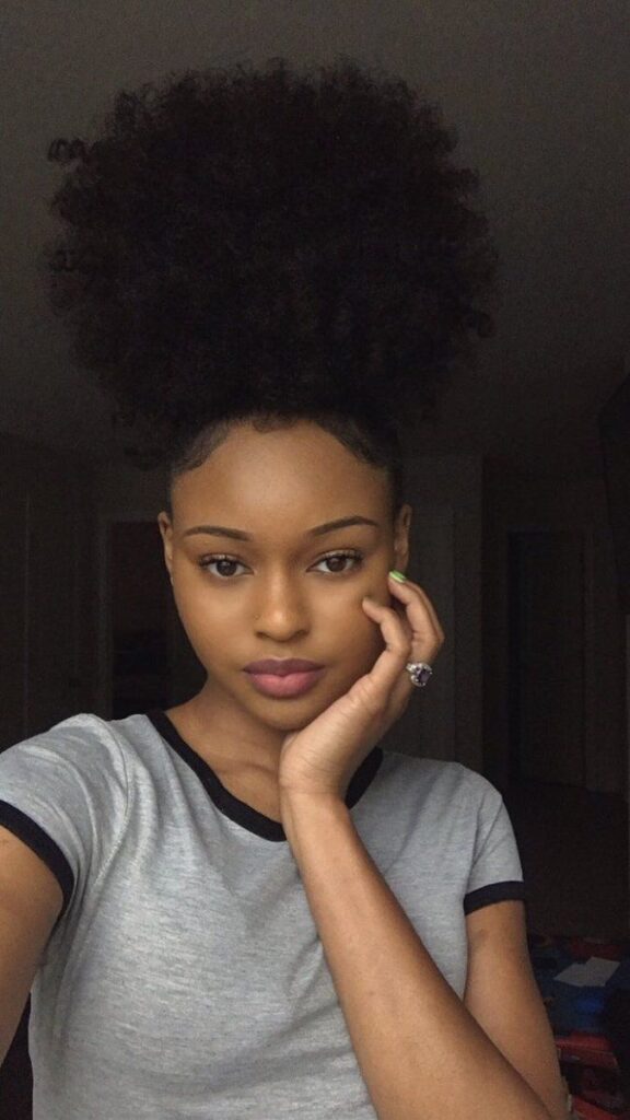 a girl with high puff quick natural hairstyle