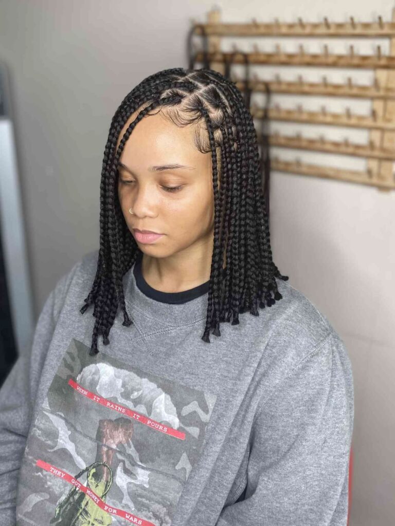 a fair girl with knotless braids