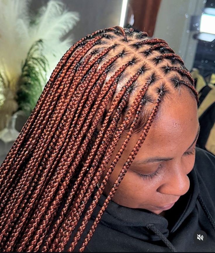 a lady with knotless braids beautiful hairstyle
