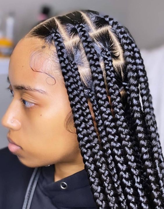 a girl with big knotless braids