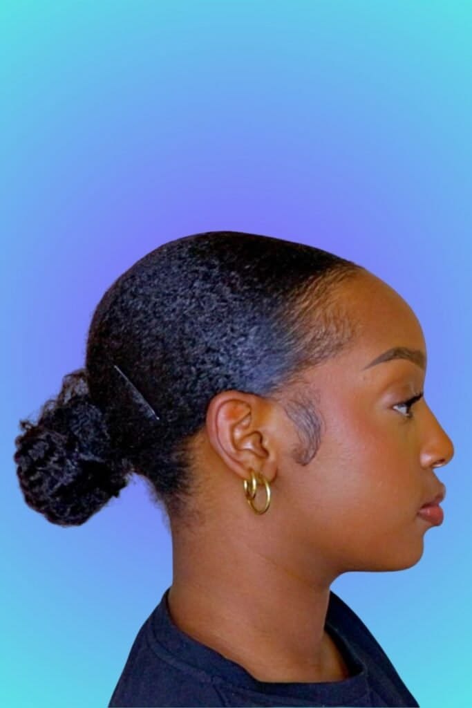a girl with low bun quick natural hairstyle