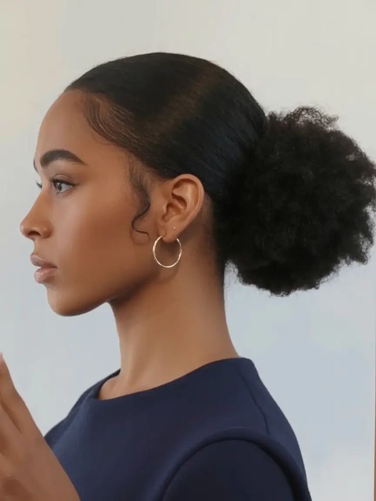a lady with low puff quick natural hairstyle
