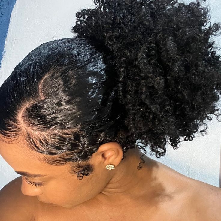 Low puff hairstyle with soft, defined natural curls.