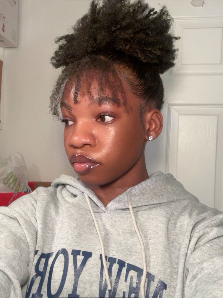 a girl with messy bun