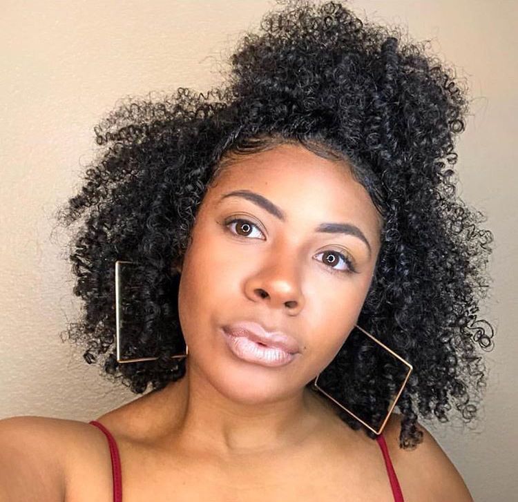 a lady with mini afro puff style