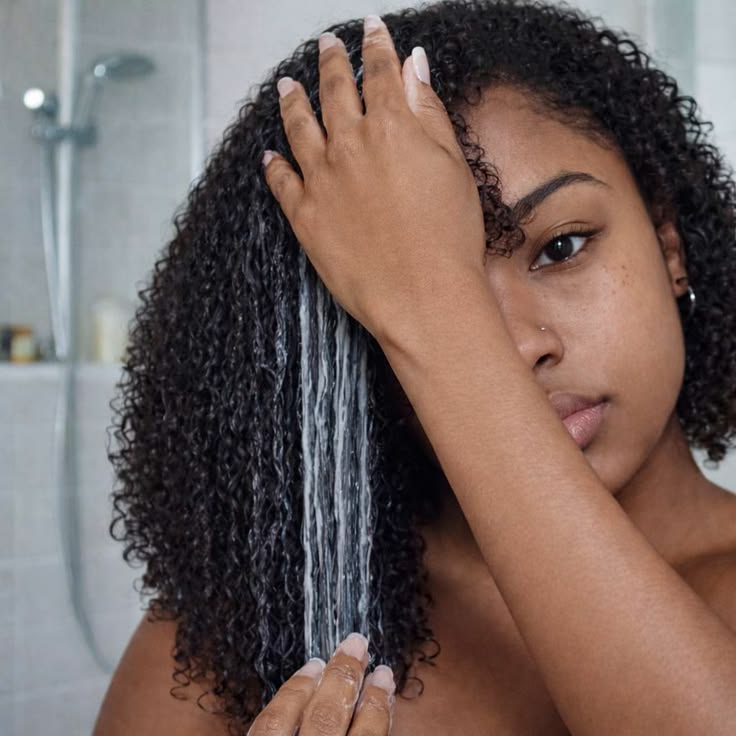 a girl moisturizing her hair