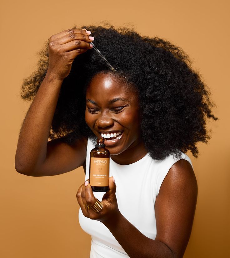 someone applying oil on a dry hair