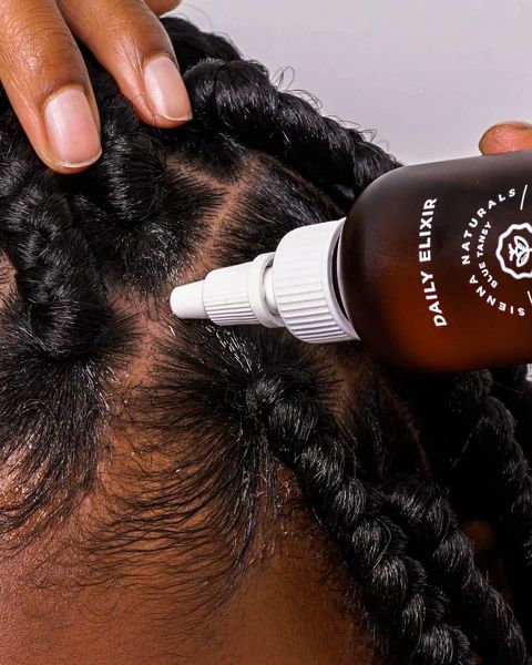 someone oiling her protective styling