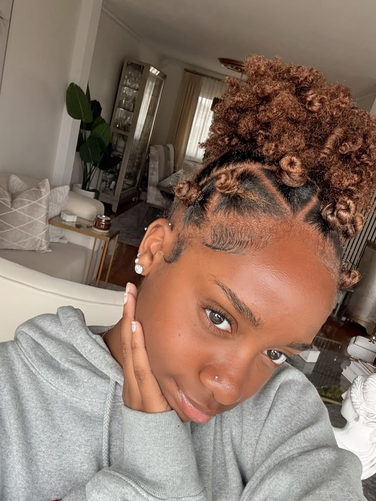 a girl packed her hair low with bantu knots at the front