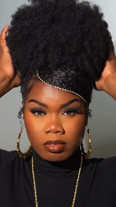 a lady with her hair packed up and beads around the edges