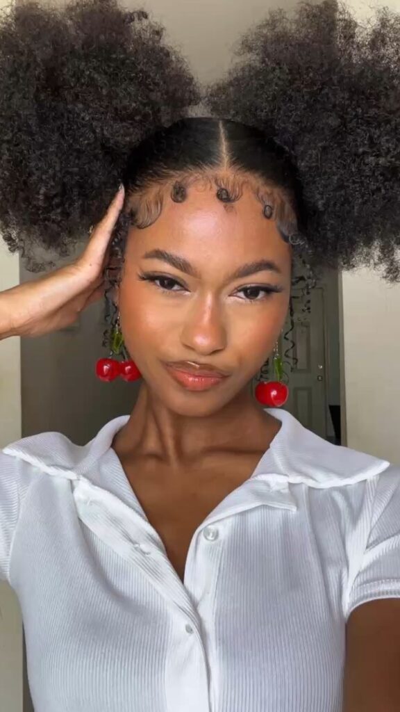 a girl packed up her hair with finger coil on the edges