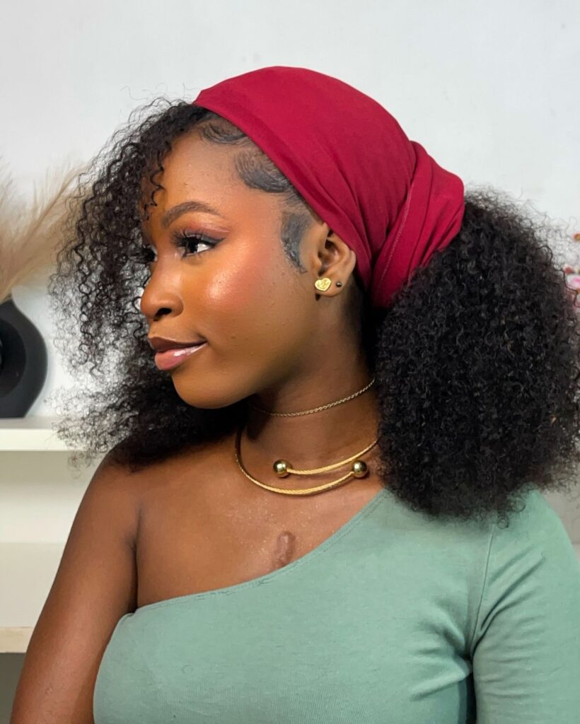 a lady with scarf wrapped hairstyle