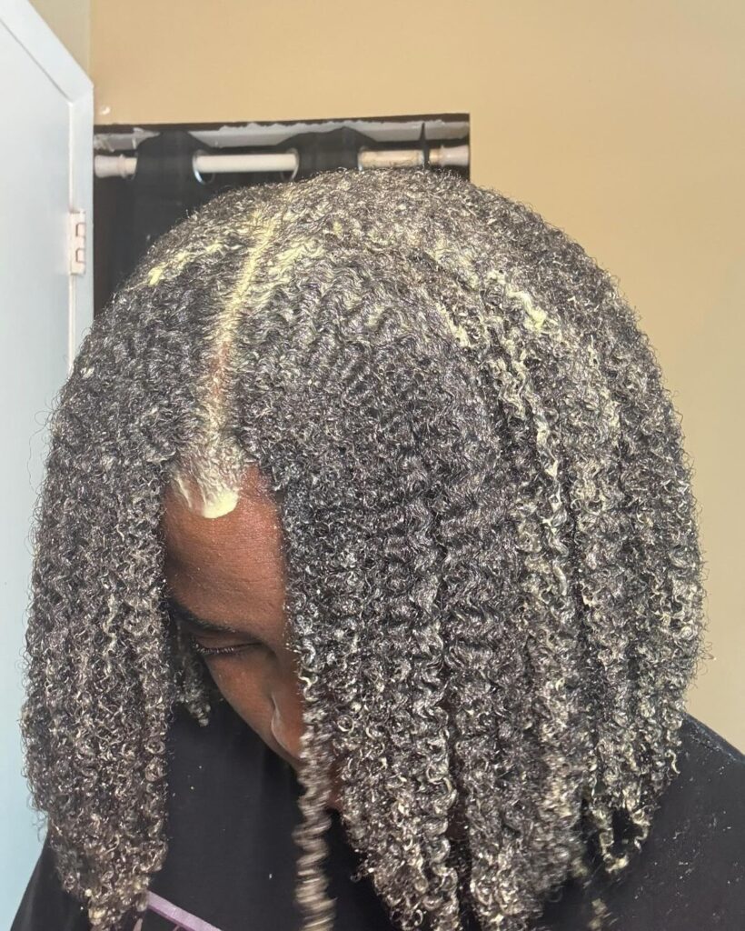 someone shampooing her curly hair
