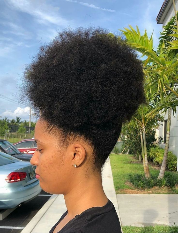 a girl with a side-swept afro puff